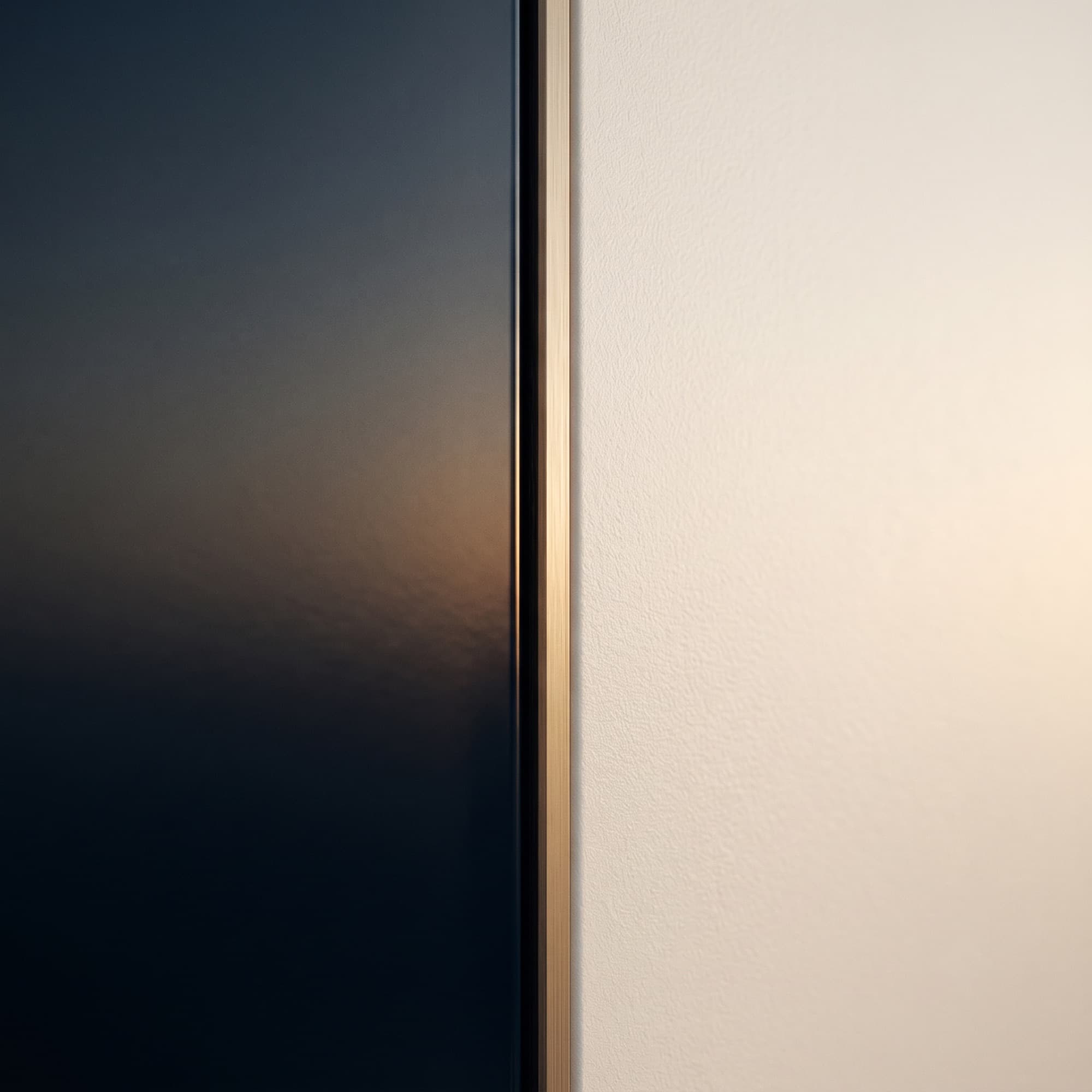 Deep navy meeting warm bone along a single fine champagne seam — one continuous line.